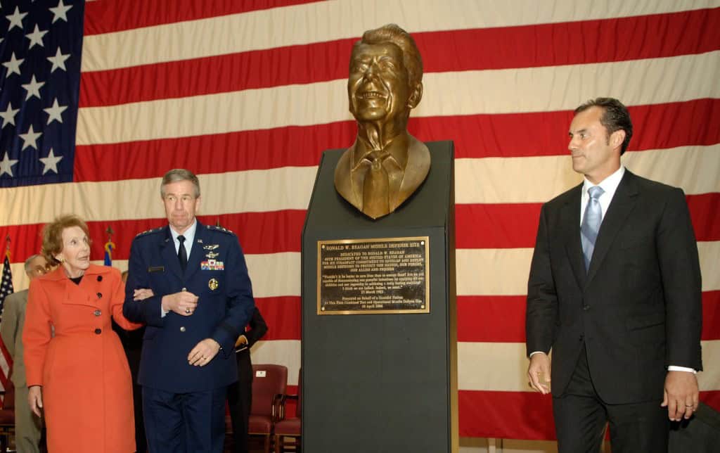 Former First Lady Nancy Reagan, escorted by Lt. Gen. Henry A. Obering III, Director Defense Missile Agency helps Mr. Riki Ellison, Founder and President, Missile Defense Advocacy Alliance, unveil a bust of President Ronald Reagan the dedication ceremony of the Ronald W. Reagan Missile Defense Site at Vandenberg Air Force Base, Calif. The program's, initiated by Reagan on March 23, 1983, mission is to develop, test and prepare for deployment a missile defense system and as ability to engage all classes and ranges of ballistic missile threats. DoD photo by Petty Officer 1st Class Chad J. McNeeley. (Released)