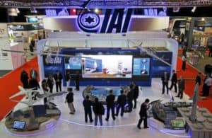 Visitors watch a demonstration at the Israel Aerospace Industries (IAI) booth in the IMDEX Asia maritime defence exhibition in Singapore May 19, 2015. REUTERS/Edgar Su/File Photo