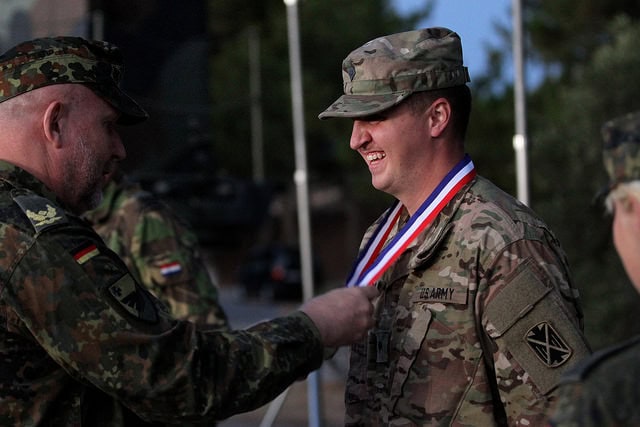 German BG Gschossmann awarding American SPC Justin Shultz of the 5-7 ADA. (Photo Credit: 10th AAMDC Flikr Page.)