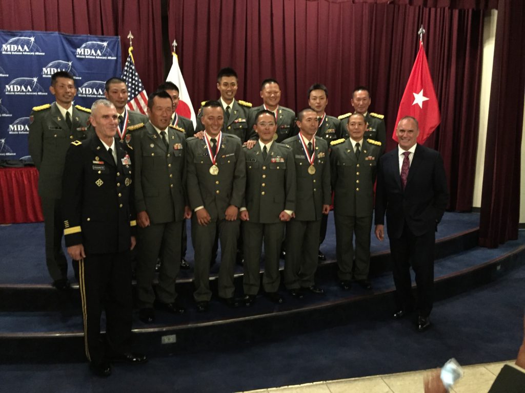 Major General Pasquarette and Riki Ellison with soldiers of the Japan Ground Self Defense Force 15th Anti-Aircraft Artillery Regiment.